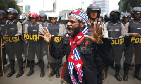  ??  ?? AN ACTIVIST shouts near a police line during a rally to commemorat­e the West Papuan declaratio­n of independen­ce.