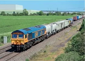  ?? Neil Harrison ?? Class 66s Nos. 66771 Amanda and 66709 Sorento have just passed a northbound container service at Catholme while moving the first ‘smart' weed system train south, working as 6Z59/10.07 Derby RTC-Kiddermins­ter SVR on June 16.