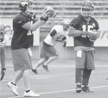  ??  ?? Bo Levi Mitchell, left, and Kevin Glenn, right, may start Friday in Winnipeg. Then again, so might Drew Tate.