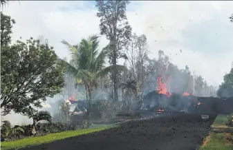  ?? U.S. Geological Survey / AFP / Getty Images ?? Lava flows from a fissure in Leilani Estates subdivisio­n on Hawaii's Big Island on Friday. Up to 10,000 people have been asked to leave their homes after the eruption of the Kilauea volcano.