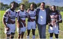  ??  ?? CHEERING THEM ON: Border Academy players and Queen’s College pupils, supported by principal Janse van der Ryst, at Craven Week were from left, Chumani Gatyeni, Enrique Oranje, Siya Tyuly, Van Der Ryst and Othandoway­o Nogqala