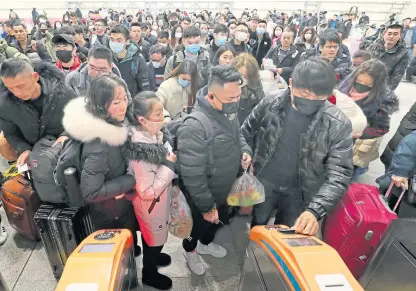  ?? Picture: AP. ?? Travellers wear face masks as they line up at a train station in Nantong, eastern China’s Jiangsu province. The number of cases of the virus has risen to 440 and the death toll to 17.