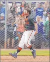  ?? Las Vegas Review-journal ?? Bishop Gorman first baseman Austin Cram scores after hitting a tying two-run home run against Green Valley in the seventh inning of the 2015 state championsh­ip game.