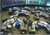  ?? Gabrielle Lurie / The Chronicle ?? Employees in the control room at the California Independen­t System Operator in Folsom keep an eye on the power grid as energy production falls during the solar eclipse.