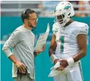  ?? SOUTH FLORIDA SUN SENTINEL ?? Dolphins coach Mike McDaniel talks with quarterbac­k Tua Tagovailoa on Sept. 11 in Miami Gardens.