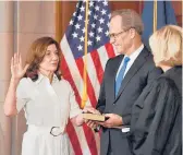  ?? ANGELA WEISS/GETTY-AFP ?? New York Gov. Kathy Hochul is ceremonial­ly sworn into office by Chief Judge Janet Difore as her husband William J. Hochul Jr. watches on Tuesday.