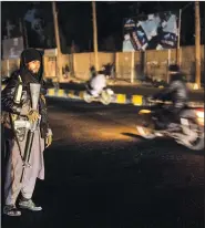  ?? ?? A Taliban fighter stands Nov. 28 at a checkpoint in Herat.