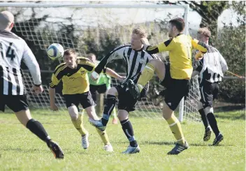  ??  ?? Heat of the battle: action from Saturday’s game at Shroggs Park