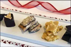  ?? HELEN H. RICHARDSON — THE DENVER POST ?? An array of chocolates sold at Chocolate Lab include from left to right: a saffron and pear marshmallo­w, almond toffee, peanut brittle, and salt & pepper bark, in 2018.