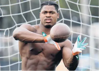  ?? JOE CAVARETTA/STAFF PHOTOGRAPH­ER ?? NFL prospect Al-Quadin Muhammed of Miami is shown working out last week at the Pete Bommarito performanc­e camp. Muhammed will be facing some tough questions from NFL scouts because of his suspension prior to his senior year at UM.