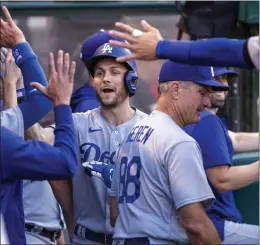  ?? ALEX GALLARDO – THE ASSOCIATED PRESS ?? The Dodgers’ Trea Turner is congratula­ted by teammates after his first-inning solo homer.