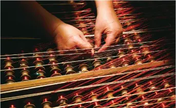  ??  ?? A woman works at the Bevilacqua textiles in Venice, Italy.