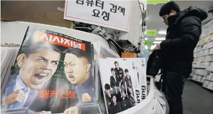  ?? AHN YOUNG-JOON/THE ASSOCIATED PRESS FILES ?? A magazine, reading ‘Hacker War,’ with cartoons of U.S. President Barack Obama and North Korean leader Kim Jong Un is displayed in Seoul, South Korea on Saturday. The U.S. imposed new sanctions Friday on North Korean government officials.