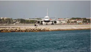  ?? (Jon Nazca/Reuters) ?? A BRITISH AIRWAYS plane is seen on the tarmac before taking off at Gibraltar Internatio­nal Airport on August 4, 2013.