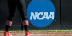  ?? AARON M. SPRECHER — THE ASSOCIATED PRESS FILE ?? An athlete stands near a NCAA logo during a softball game in Beaumont, Texas.