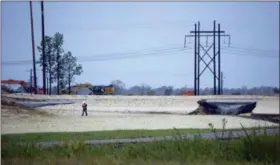  ?? KEMP BURDETTE — CAPE FEAR RIVER WATCH VIA AP ?? On Sunday, gray water containing coal ask flows from a ruptured landfill at the L.V. Sutton Power Station in Wilmington, N.C., and flows toward Sutton Lake, near the Cape Fear River.