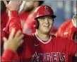  ?? ASSOCIATED PRESS FILE PHOTO ?? Los Angeles Angels’ Shohei Ohtani is greeted in the dugout after he hit a solo home run during the first inning of an Oct. 3game against the Seattle Mariners in Seattle.