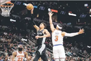  ?? — AFP photo ?? Wembanyama drives past Josh Hart of the New York Knicks in the first half at Frost Bank Centre in San Antonio, Texas.