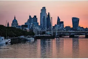  ?? PA ?? > Morning light bathes the skyscraper­s of the City of London financial district