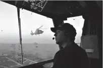  ?? AP Photo/Dario Lopez-Mills ??      An unidentifi­ed U.S. Coast Guardsman communicat­es with the pilot of a helicopter during takeoff and landing exercises March 2, 2017, on the cutter Stratton in the eastern Pacific Ocean. The Coast Guard is teaming up with Mexican and Colombian...