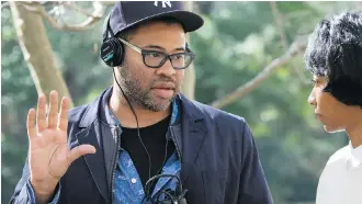  ??  ?? Writer-director Jordan Peele and actress Betty Gabriel are shown on the set of the horror-comedy Get Out.