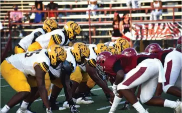  ?? (Pine Bluff Commercial/ I.C. Murrell) ?? Watson Chapel offensive players, in yellow helmets, line up for a play against Pine Bluff High School on Aug. 27.