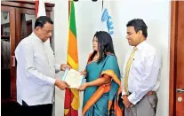  ??  ?? Maelge receiving the official letter of appointmen­t from Minister John Amaratunga . SLTPB Chairman Kishu Gomes looks on