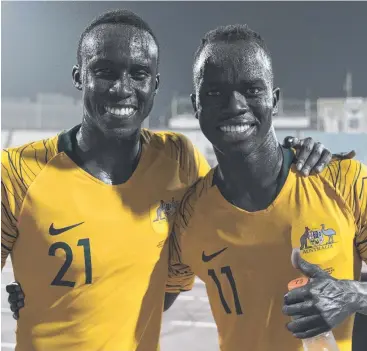  ?? Picture: AAP/FOOTBALL FEDERATION AUSTRALIA ?? GRINNERS: Socceroos Thomas Deng and Awer Mabil celebrate the win