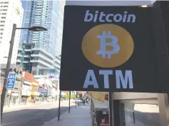  ?? (Chris Helgren/Reuters) ?? A SIGN is seen outside a business where a bitcoin ATM is located in Toronto.