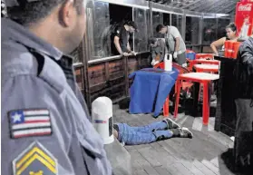  ?? Biaman Prado / Associated Press ?? The body of newspaper reporter Decio Sa lies on the floor of a restaurant in Sao Luis, Brazil, after a gunman shot him six times Monday night.