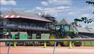  ?? Photos by Will Waldron / Times Union ?? Preparatio­ns are underway for Thursday’s opening day at Saratoga Race Course.