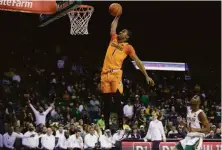  ?? Ron Jenkins / Getty Images ?? Oklahoma State’s Bryce Thompson dunks in the first half against Baylor; he closed the scoring with a slam as well.