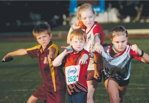  ?? Picture: STEWART MCLEAN ?? RARING TO GO: Cairns athletes Thomas Miles, 8, Quinn Lenton-Cater, 4, Ava Lenton-Cater, 10, and Haylee Sorenson, 10, are ready to compete at today’s Twilight Event at Barlow Park.