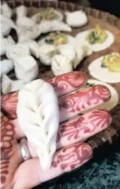  ?? | The Washington Post ?? IN the momo-making class, Julie Lopez shows off her dumpling-folding skills.