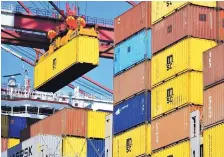  ?? CHINATOPIX VIA ASSOCIATED PRESS ?? A container is loaded onto a cargo ship at a port in eastern China. The Chinese government has accused the United States of using blackmail in its threat to impose tariffs on Chinese imports.