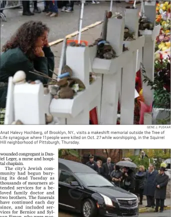  ?? GENE J. PUSKAR ?? Anat Halevy Hochberg, of Brooklyn, NY., visits a makeshift memorial outside the Tree of Life synagogue where 11 people were killed on Oct. 27 while worshippin­g, in the Squirrel Hill neighborho­od of Pittsburgh, Thursday.