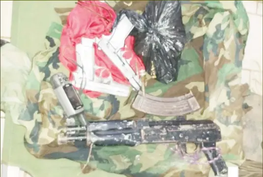  ??  ?? The items recovered including the AK-47 rifle and two handguns