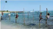  ??  ?? Stilt fishermen in Sri Lanka.