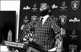  ?? STEVE MARCUS ?? Christian Wilkins, a 6-foot-4, 310-pound defensive tackle, displays a jacket with a playing cards design in the liner Thursday during a news conference at Raiders Headquarte­rs in Henderson. Wilkins joins the Raiders after spending the past five seasons with the Miami Dolphins.