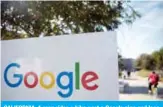  ?? — AFP ?? CALIFORNIA: A man rides a bike past a Google sign and logo at the Googleplex in Menlo Park, California.