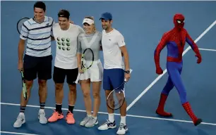  ?? AP ?? (From left to right) Milos Raonic, Roger Federer, Caroline Wozniacki and Novak Djokovic with a spiderman pose for a photo during the Kids Tennis Day event on Rod Laver Arena in Melbourne. —