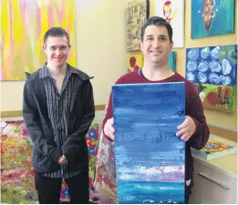  ?? PHOTO: PAM JONES ?? Creative work . . . Living Options artists Logan Winter (left) and Andrew Wallace display some of the work that will feature in the Living Options Alexandra Thyme Festival exhibition. Mr Winter will exhibit the yellow painting that is behind him, and Mr Wallace will exhibit several works, including the seascape he is holding. The annual thyme festival opens this Saturday and the Living Options exhibition opens next Tuesday.