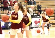  ?? Photo by Becky Polaski ?? Elk County Catholic Lady Crusader seniors Tori Newton, Lucy Klawuhn, and Sami Straub are all shown wearing pink ribbons in memory of Hannah Rose Pistner during warmups for Saturday’s D9-1A girls’ championsh­ip game at PennWest Clarion.