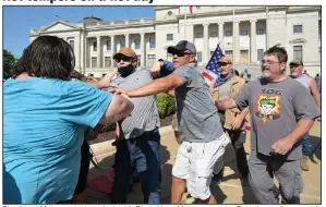  ?? (Arkansas Democrat-Gazette/Stephen Swofford) ?? Blue Lives Matter protesters clash with Black Lives Matter protesters Saturday as they meet in front of the state Capitol in Little Rock. The Blue Lives Matter group marched from the Clinton Presidenti­al Center to the Capitol, where the counterpro­testers “tried to block their path,” a police spokesman said. Several fights broke out. Tensions also were high at another Black Lives Matter protest in Sheridan, but police maintained order. More photos at arkansason­line.com/719lrprote­st/.