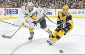  ?? Keith Srakocic The Associated Press ?? Golden Knights defenseman Jake Bischoff (45) and Pittsburgh Penguins left wing Dominik Kahun chase after the puck Saturday.