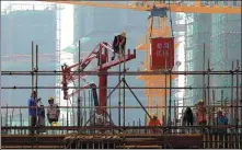  ?? ZHOU CHANGGUO / FOR CHINA DAILY ?? Workers at the constructi­on site of a property project in Huai’an, Jiangsu province.