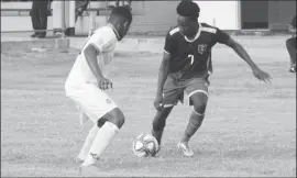  ??  ?? Guyana’s Kelsey Benjamin [no.7] trying to get past his Surinamese marker during their clash in an internatio­nal friendly at the Pierkhan Stadium, Nickerie, Suriname