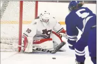  ?? Dave Stewart / For Hearst Connecticu­t Media ?? New Canaan goalie Blythe Novick blocks a shot from Darien’s Cate Droogan for one of her 21 saves on Saturday.