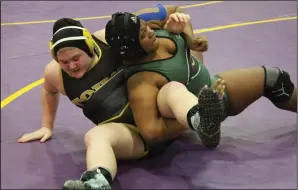  ?? MIKE BUSH/NEWS-SENTINEL ?? Above: Tokay's Cassidy Curtiss (left) brings down Casa Grande's Lilly McCoy in their first place bout in the heavyweigh­t division at the Lady Tiger Invitation­al at The Jungle on Jan. 12. Below: Tokay's Cassidy Curtiss, left, wrestles recently in Fargo, N.D.