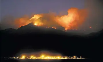  ?? KELLY PRESNELL ARIZONA DAILY STAR VIA AP ?? The Frye Fire burns the western edge of the Pinaleño Mountains in Coronado National Forest above Fort Grant Prison near Willcox, Ariz., on Thursday.